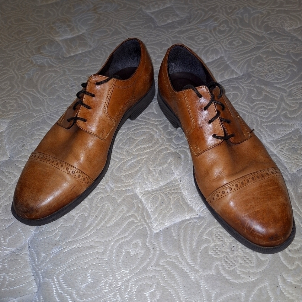 A pair of Cole Haan Oxfords in a men's size 12M. Pre-loved in good condition.